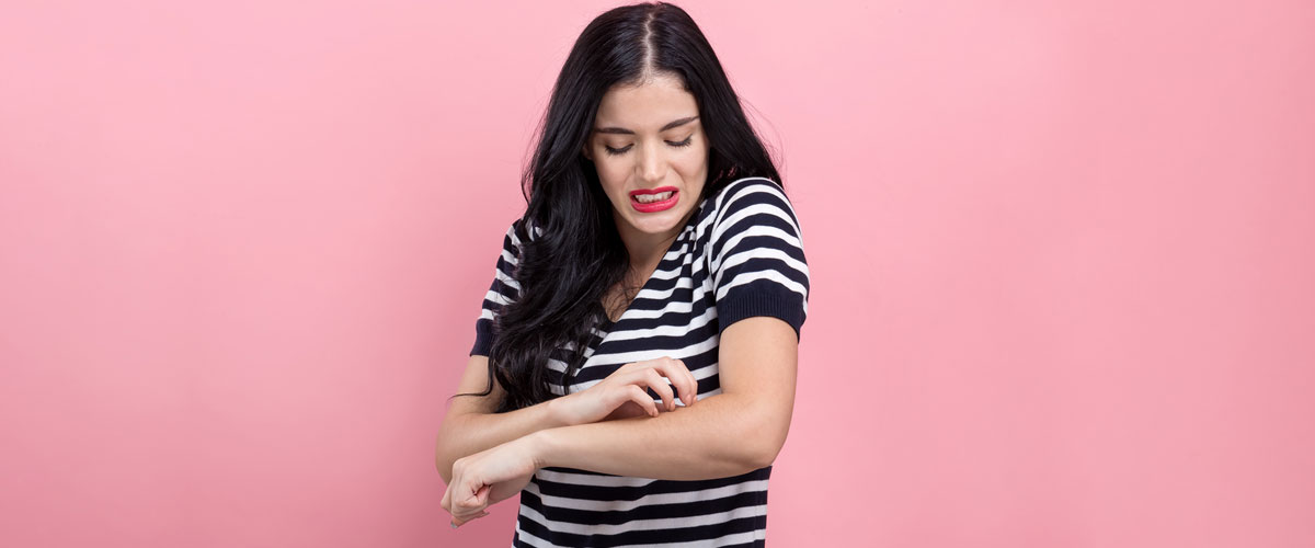 Young woman itching her hand